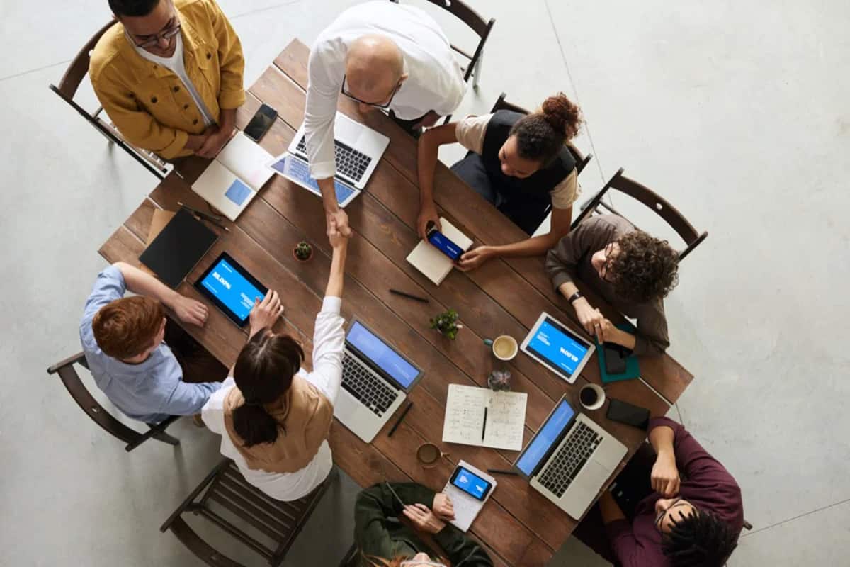 A ministry team working together around a table with laptops and notes