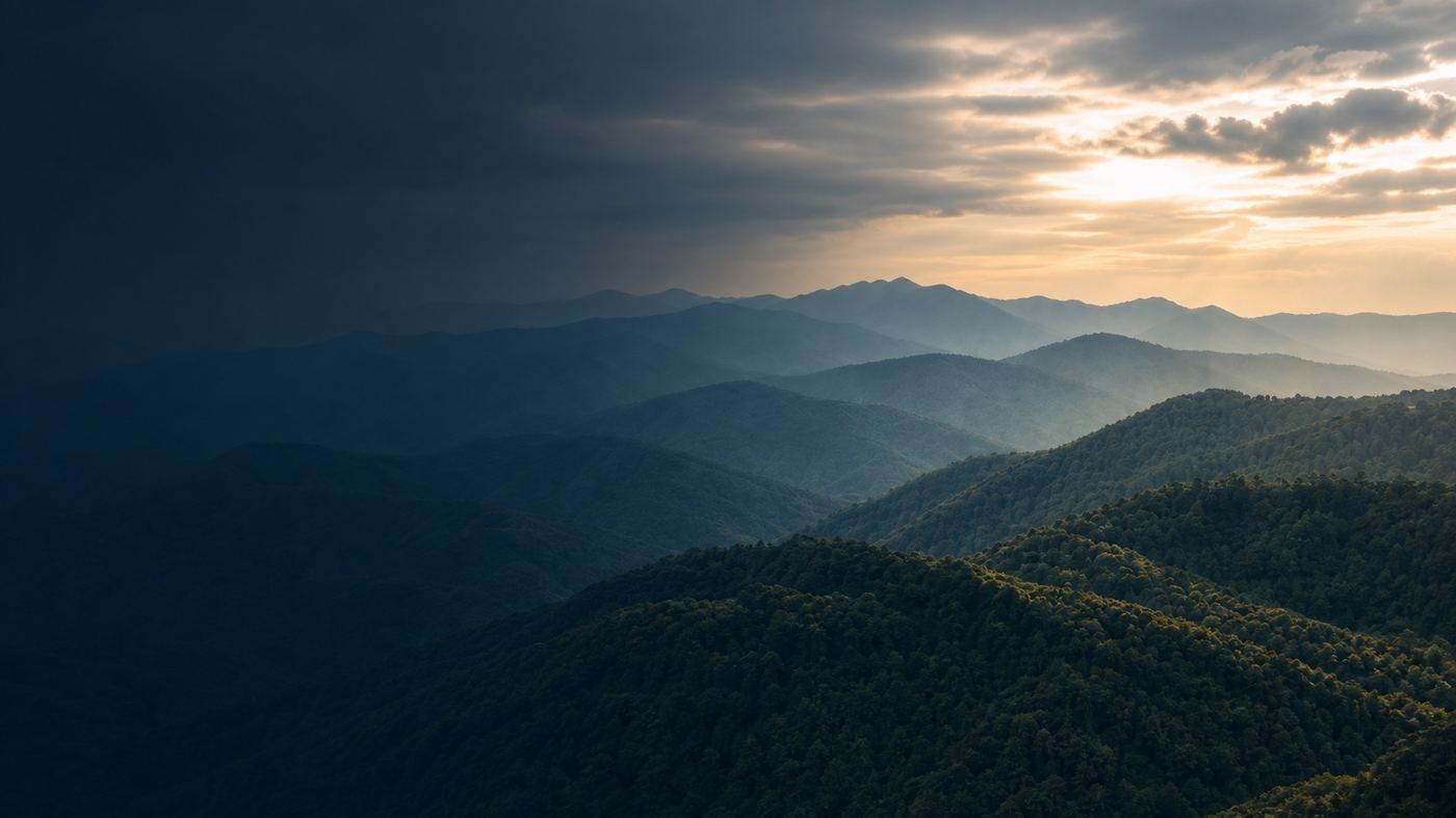 Morning light over forested mountain ridges